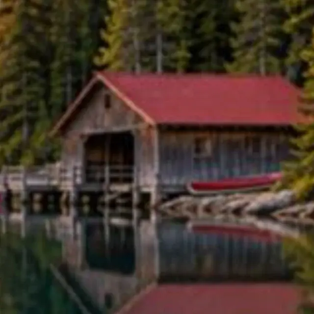 Soft photo of a mountain lake with a boathouse, detail crop: Original