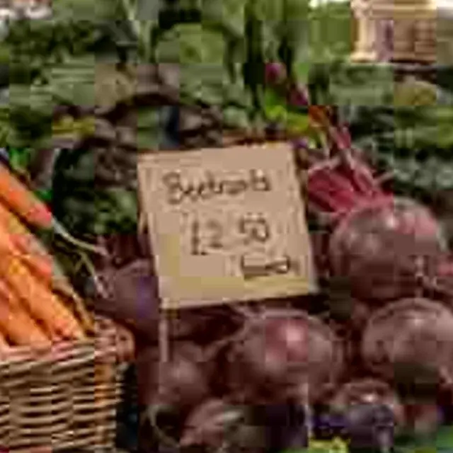 Heavily compressed JPEG of a market stall with price tags, detail crop: Original