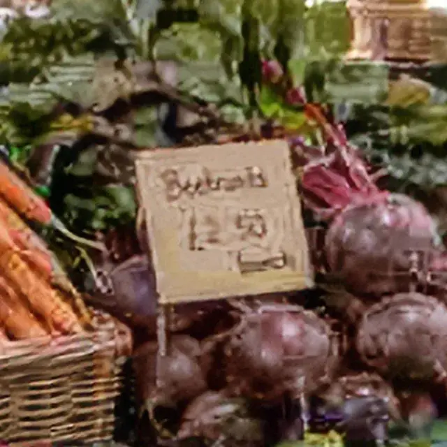 Heavily compressed JPEG of a market stall with price tags, detail crop: Pic Refiner v2.1