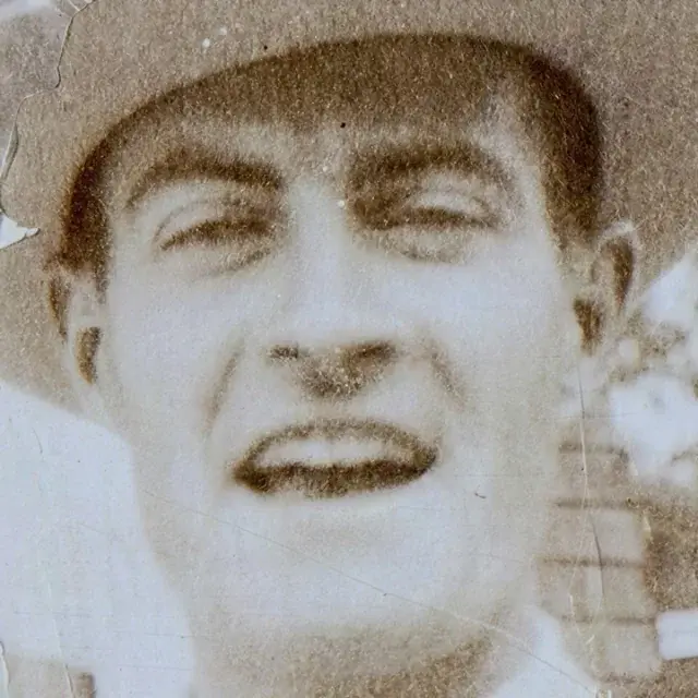 Faded 1920s photo of a man in a hat with cracks, detail crop: Hyper Upscale v4