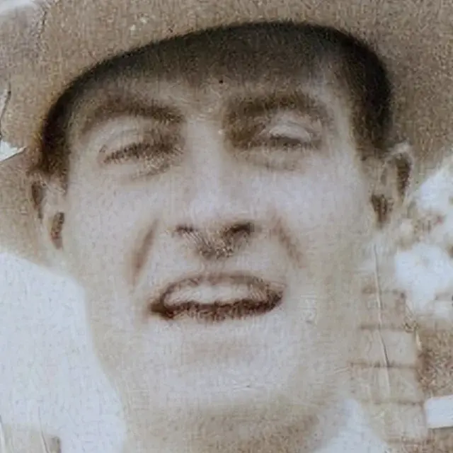 Faded 1920s photo of a man in a hat with cracks, detail crop: Pic Refiner v2.1