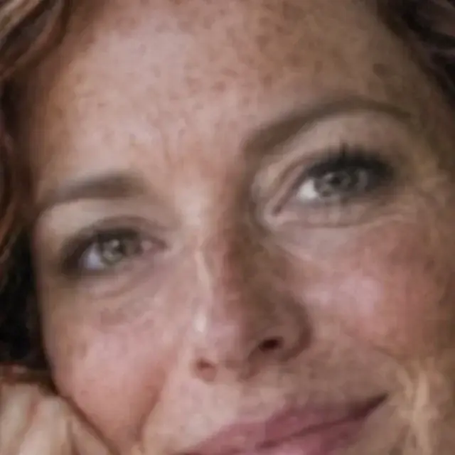 Small blurry portrait of a woman with freckles, detail crop: Pic Refiner v2.1